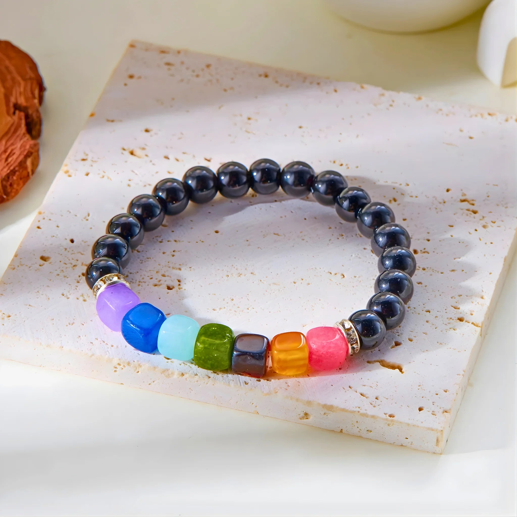 Ambition gemstone bracelet displayed on stone slab.