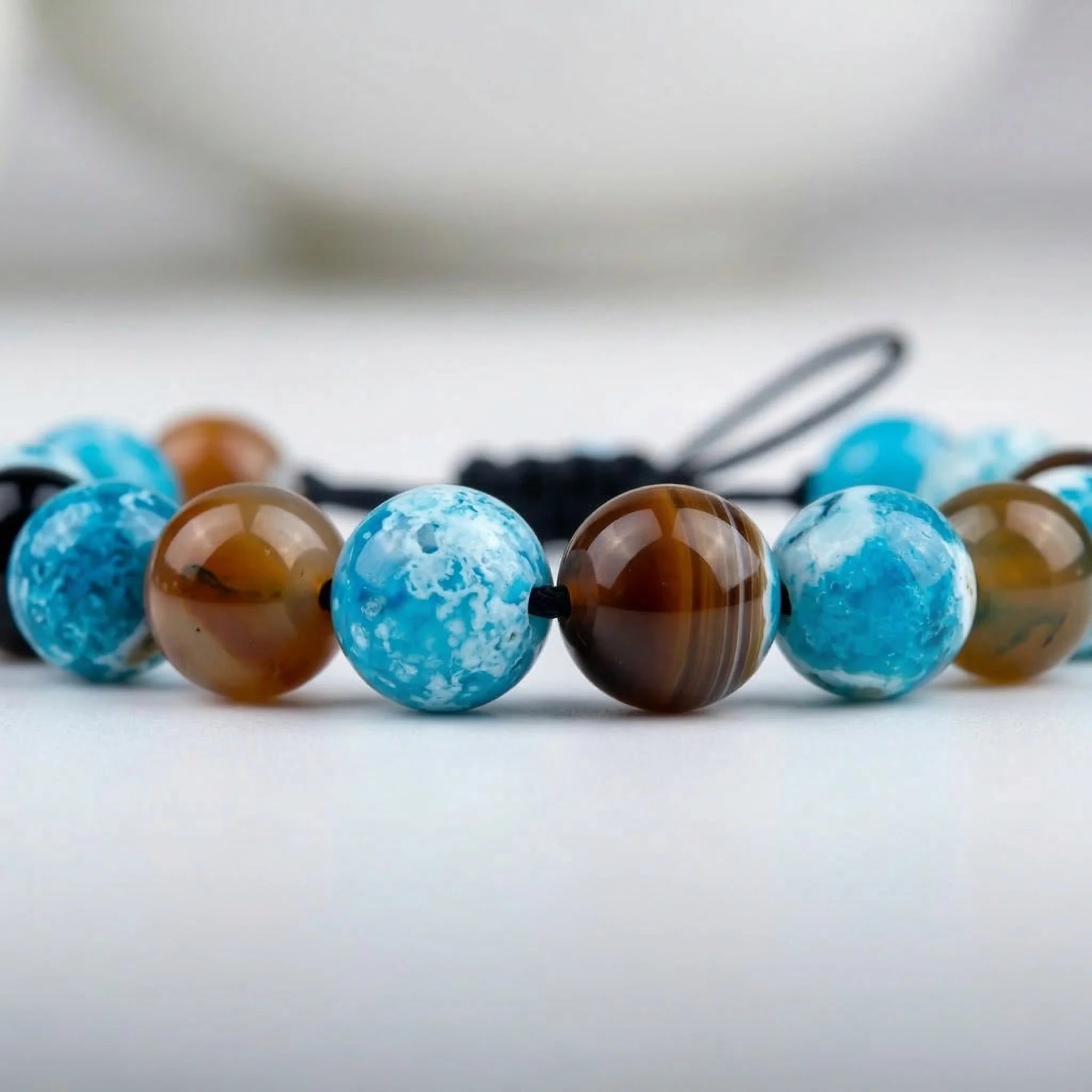 Necklace with blue and brown beads on a blurred background