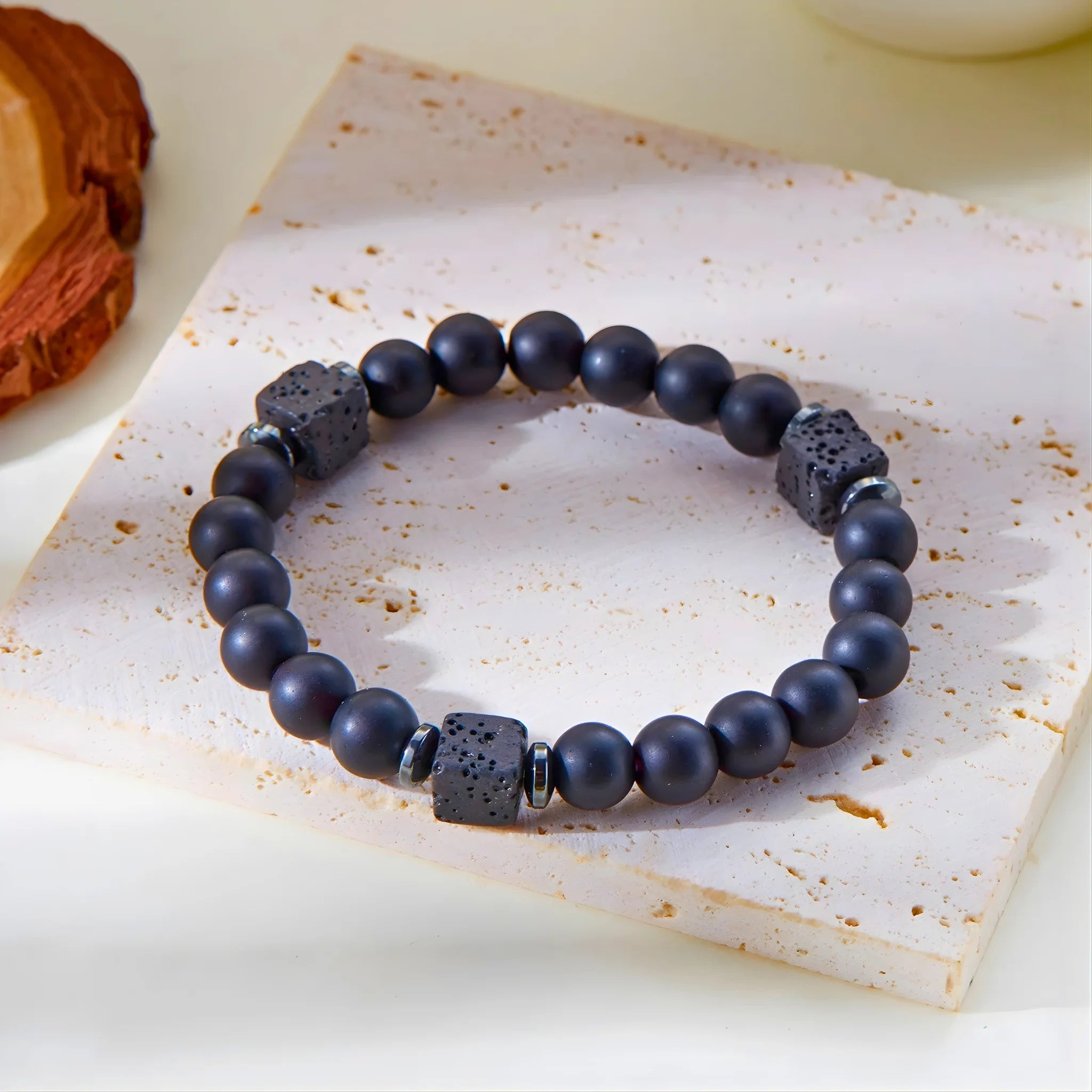 Calm gemstone bracelet displayed on stone slab.