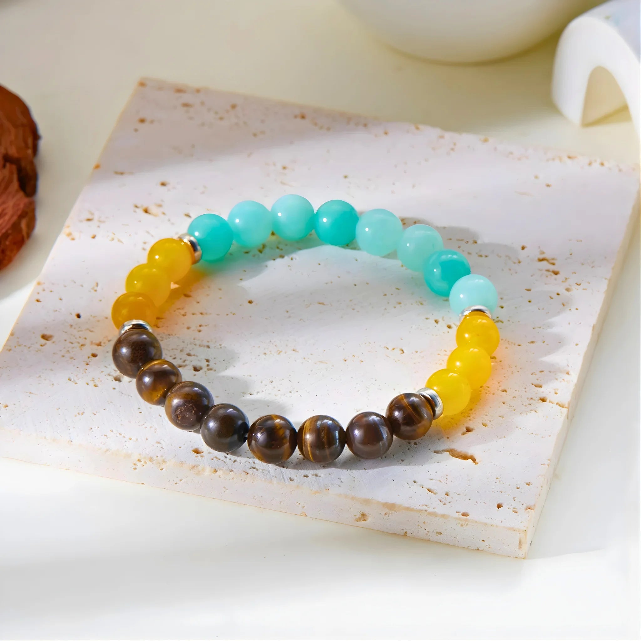 Good Luck gemstone bracelet displayed on stone slab for detail and texture.