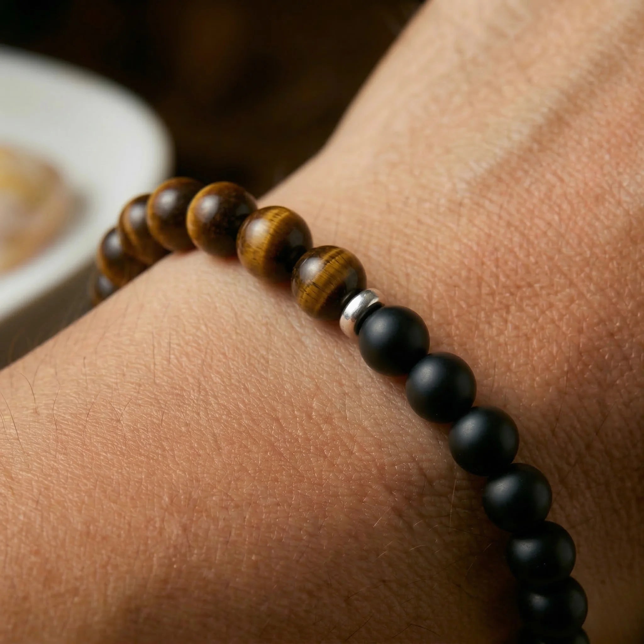 Close-up of a beaded bracelet on a wrist with a blurred background