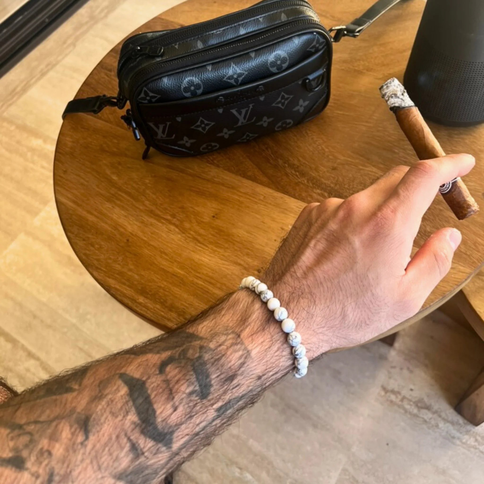 Gemstone4K howlite bracelet worn on wrist, showing white marbled stones symbolizing calm and peace.