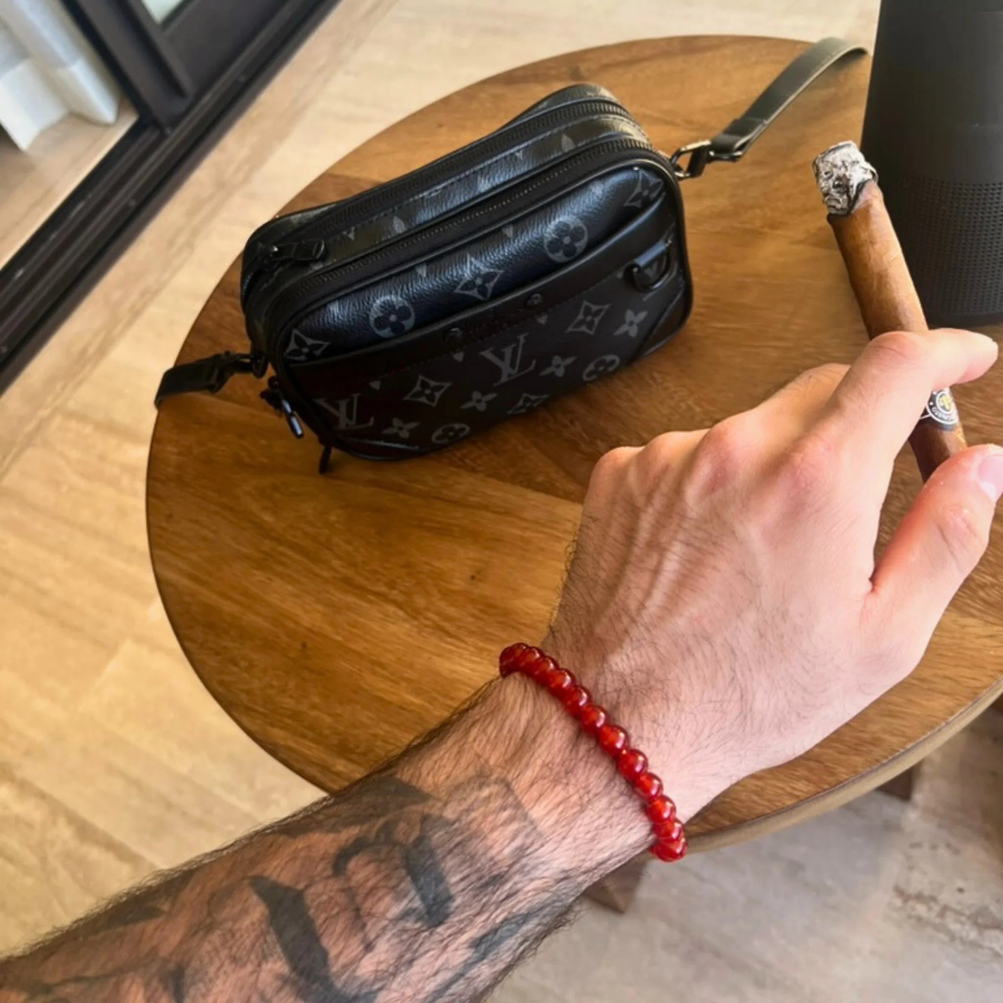 Gemstone4K red jasper bracelet worn on wrist outdoors, showing natural red earthy tone and polished beads.