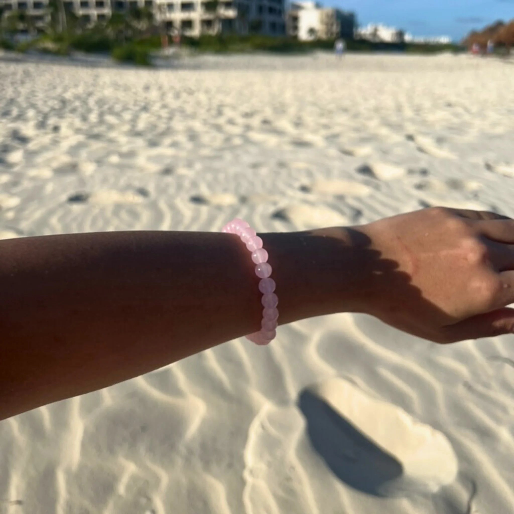Gemstone4K rose quartz bracelet worn on wrist in soft natural light, highlighting pink calming tones.