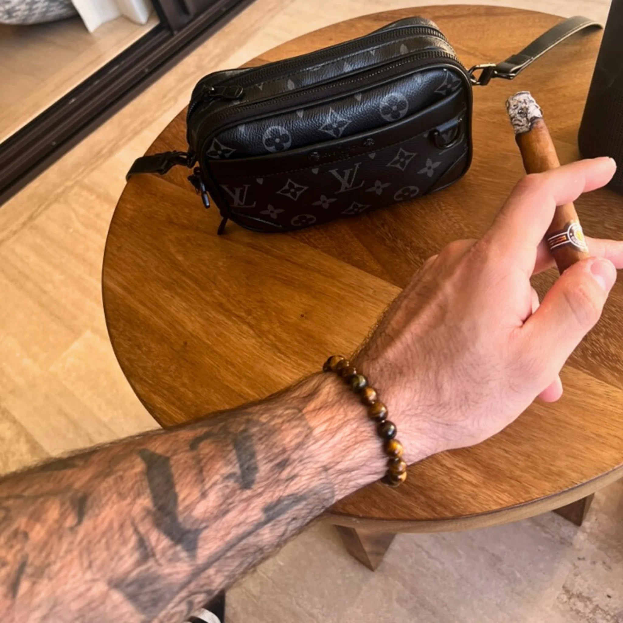 Gemstone4K tiger’s eye bracelet worn on wrist, showing golden brown tones and natural shine.