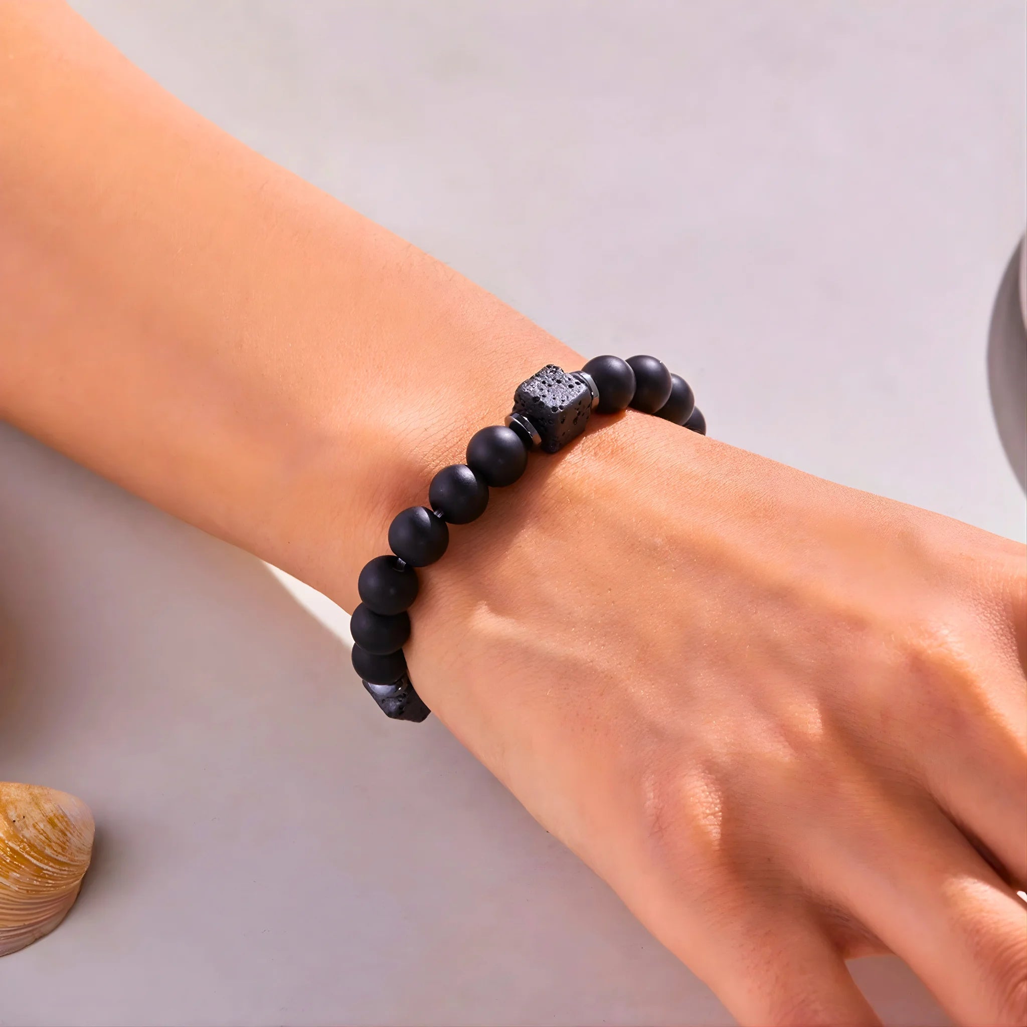 Model wearing the Calm empowerment bracelet on wrist.