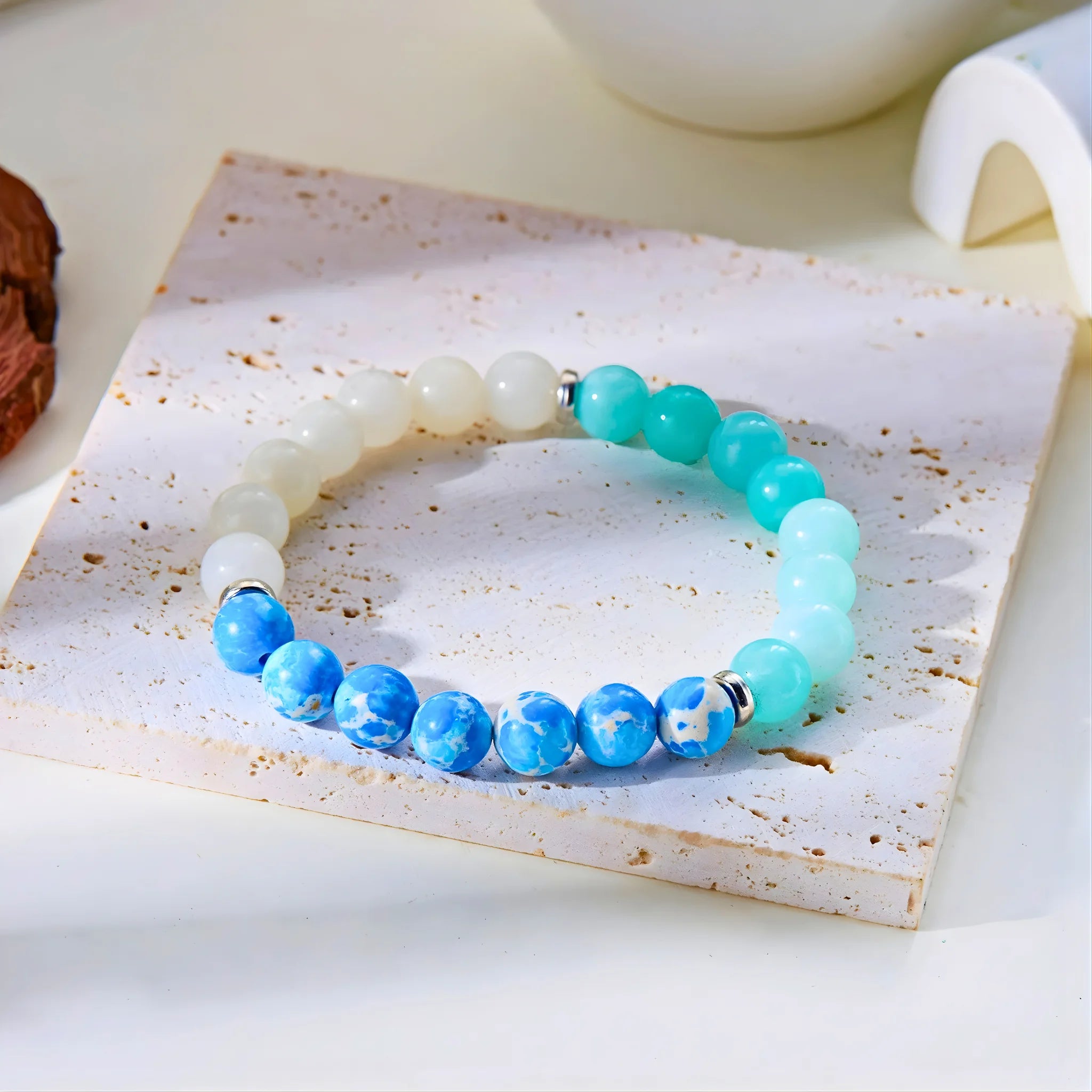 Friendship gemstone bracelet styled on stone slab.