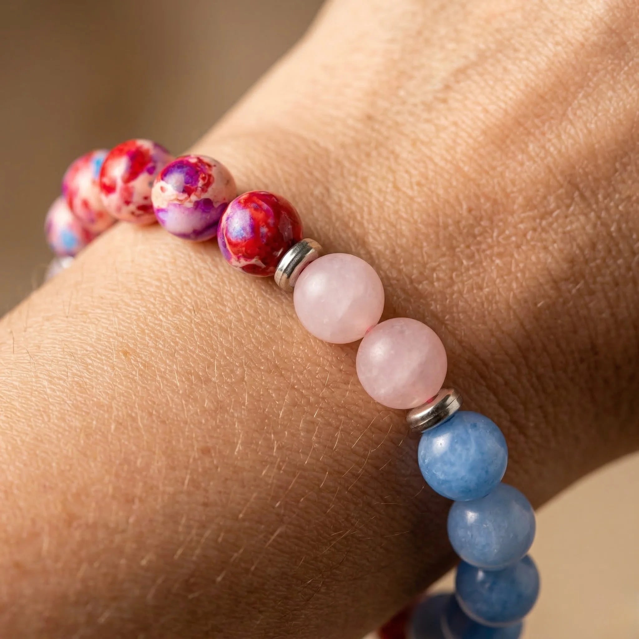 Multicolored beaded bracelet on a wrist with a blurred background