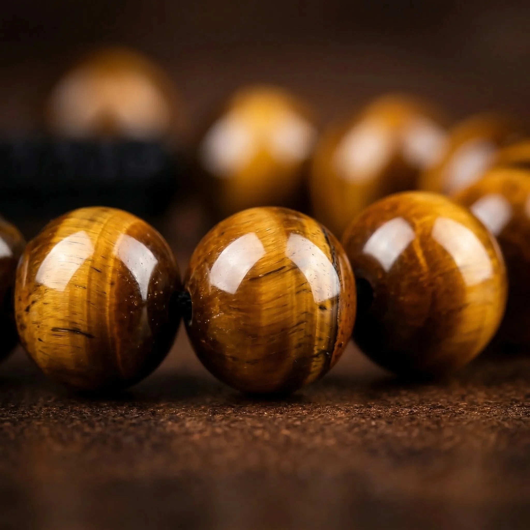 Close-up of tiger eye beads on a dark background
