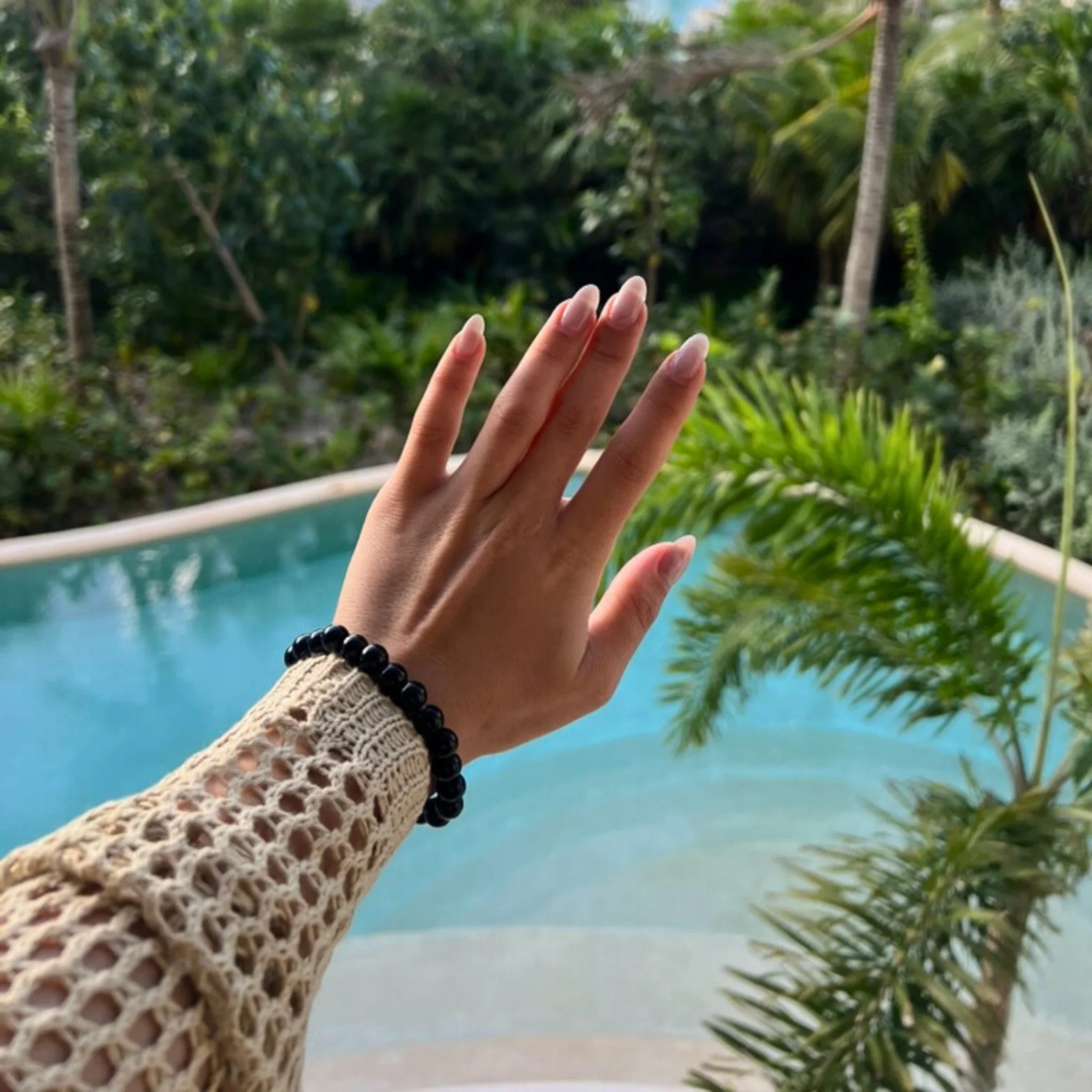 Gemstone4K onyx bracelet worn on wrist, showing deep black polished stones with a sleek appearance.