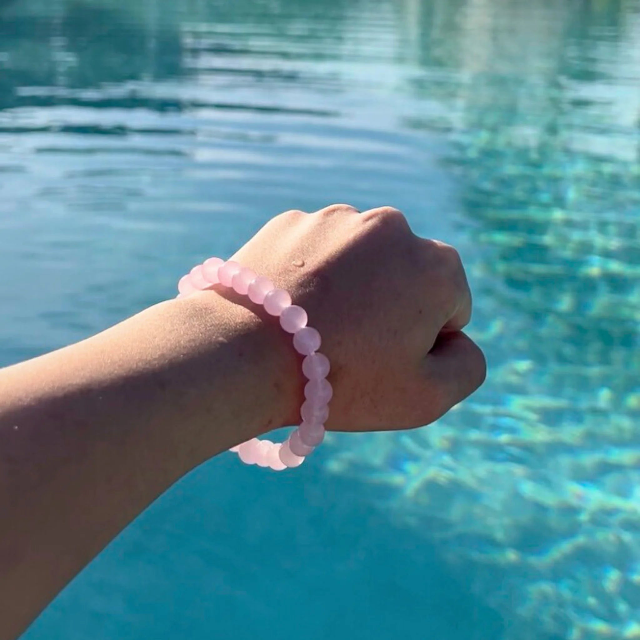 Gemstone4K rose quartz bracelet worn on wrist in soft natural light, highlighting pink calming tones.