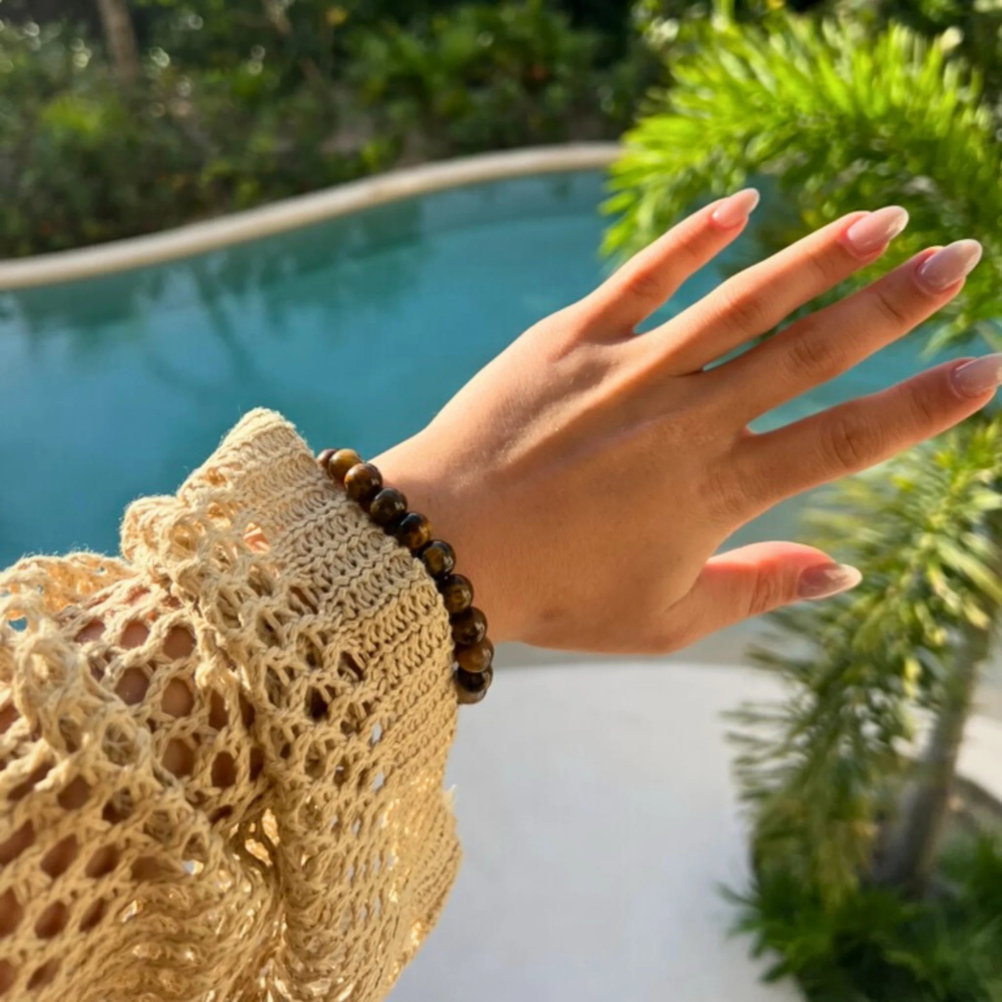 Gemstone4K tiger’s eye bracelet worn on wrist, showing golden brown tones and natural shine.